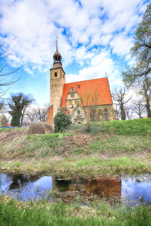 WROCLAW, POLAND - APRIL 21, 2021: Roman Catholic Church of st. Trinity (17th century, 1597-1602) situated on a small island in the river in Zorawina near Wroclaw, Poland.のeditorial素材
