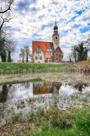 WROCLAW, POLAND - APRIL 21, 2021: Roman Catholic Church of st. Trinity (17th century, 1597-1602) situated on a small island in the river in Zorawina near Wroclaw, Poland.のeditorial素材