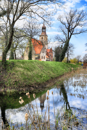 WROCLAW, POLAND - APRIL 21, 2021: Roman Catholic Church of st. Trinity (17th century, 1597-1602) situated on a small island in the river in Zorawina near Wroclaw, Poland.のeditorial素材