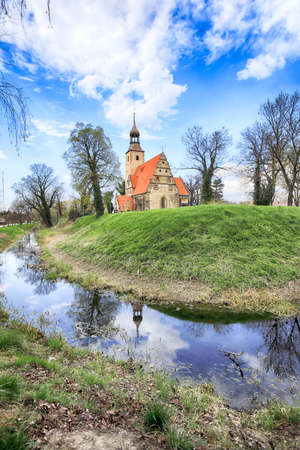 WROCLAW, POLAND - APRIL 21, 2021: Roman Catholic Church of st. Trinity (17th century, 1597-1602) situated on a small island in the river in Zorawina near Wroclaw, Poland.のeditorial素材