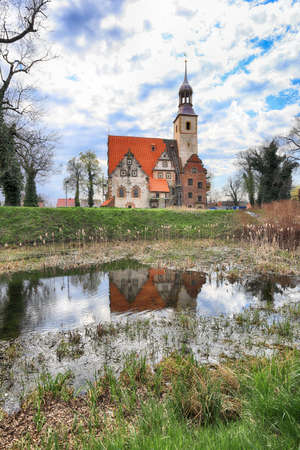 WROCLAW, POLAND - APRIL 21, 2021: Roman Catholic Church of st. Trinity (17th century, 1597-1602) situated on a small island in the river in Zorawina near Wroclaw, Poland.のeditorial素材