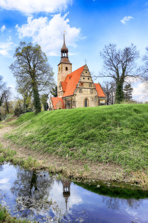 WROCLAW, POLAND - APRIL 21, 2021: Roman Catholic Church of st. Trinity (17th century, 1597-1602) situated on a small island in the river in Zorawina near Wroclaw, Poland.のeditorial素材