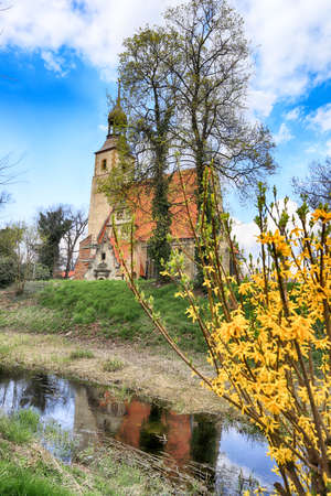 WROCLAW, POLAND - APRIL 21, 2021: Roman Catholic Church of st. Trinity (17th century, 1597-1602) situated on a small island in the river in Zorawina near Wroclaw, Poland.のeditorial素材