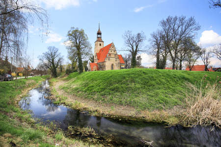 WROCLAW, POLAND - APRIL 21, 2021: Roman Catholic Church of st. Trinity (17th century, 1597-1602) situated on a small island in the river in Zorawina near Wroclaw, Poland.のeditorial素材