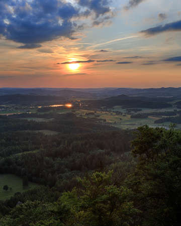 Beautiful sunset and clouds in Rudawy Janowickie (Mountains in south-west Poland, Europe). View from Krzyzna Gora (654 m above sea level) in the middle of July.の写真素材