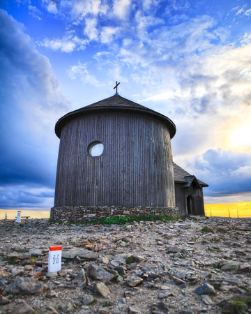 St. Lawrence's Chapel on the top of Snezka or Sniezka (in Czech and Polish) during sunset. Mountain on the border between the Czech Republic and Poland.の写真素材