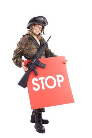 Shot of a beautiful girl holding gun. Uniform conforms to special services(soldiers) of the NATO countries. Shot in studio. Isolated on white.の写真素材