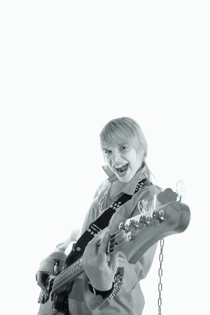 A young woman playing her guitar with expression.の写真素材