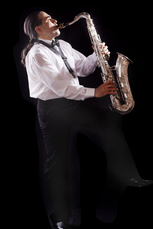 A man playing his wind instrument with expression.の写真素材