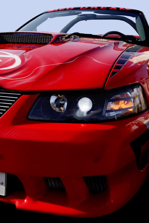 Sport red car with polished chrome trim.
