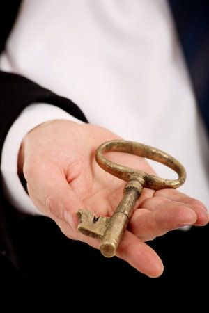 Golden key on the handの写真素材