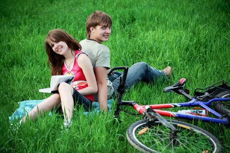 Beautiful couple lying on the grassの写真素材