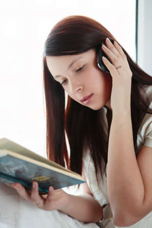 Beautiful girl with book: education, fashion.の写真素材