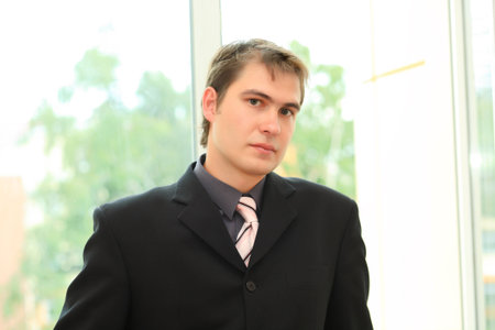 Business background: handsome businessman in a work process.