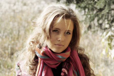Young pretty woman in the autumn park.