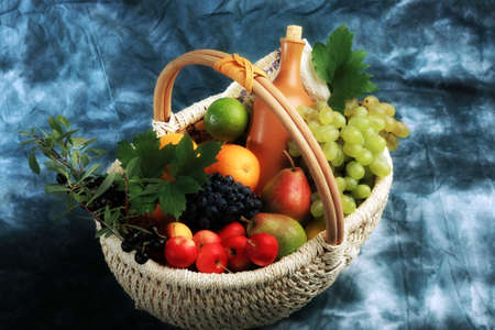 Berries and wine composition in a basket.の写真素材