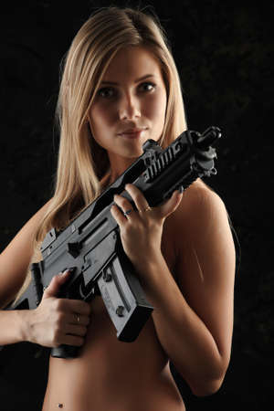 Shot of a beautiful girl holding gun.の写真素材