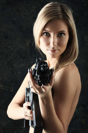 Shot of a beautiful girl holding gun.の写真素材