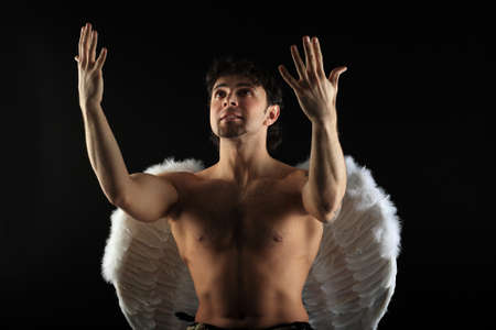 Handsome male angel. Shot in a studio.の写真素材