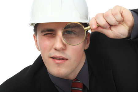 Portrait of an architecture looking through the magnifying glass.の写真素材