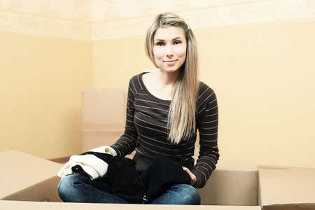 Young woman moving to a new home. の写真素材
