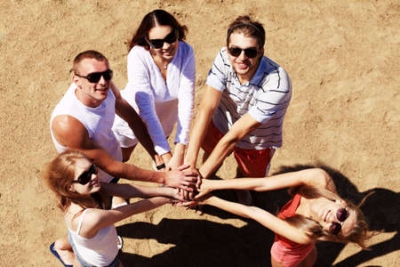 Cheerful young people having fun on a beach. Great summer holidays. の写真素材