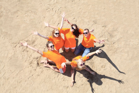 Cheerful young people having fun on a beach. Great summer holidays. の写真素材