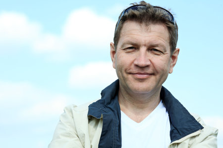 Portrait of a mature man in front of sky.