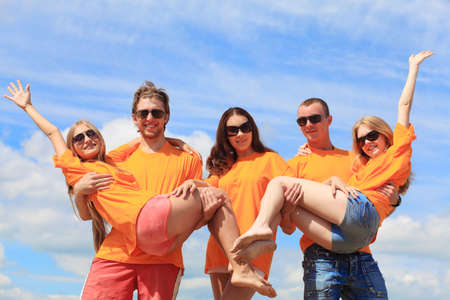 Cheerful young people having fun on a beach. Great summer holidays. の写真素材