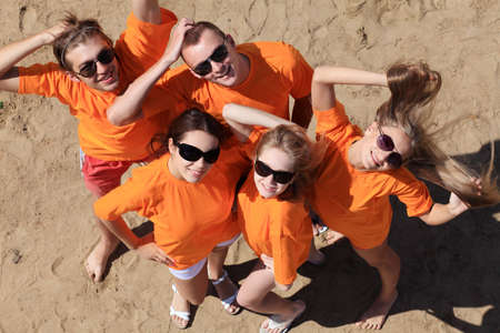 Cheerful young people having fun on a beach. Great summer holidays. の写真素材