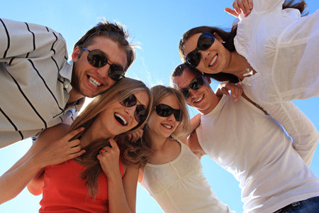 Cheerful young people having fun on a beach. Great summer holidays. の写真素材