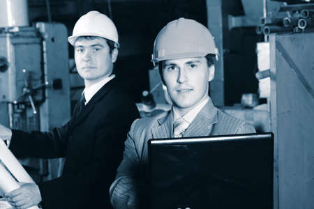 Industrial theme: two blue collars at a manufacturing area.  の写真素材