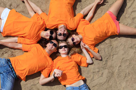 Cheerful young people having fun on a beach. Great summer holidays. の写真素材
