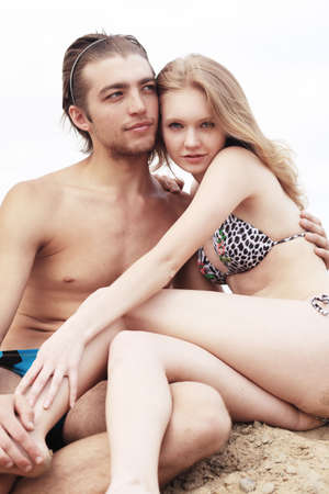 Couple of young people having a rest on a beach. Great summer holidays.の写真素材