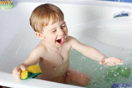 Sweet child taking a bath. 