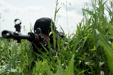 Shot of a soldier holding gun at a battlefield.