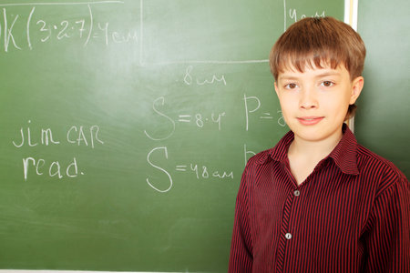 Educational theme: schoolboy in a classroom.