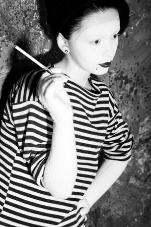 Portrait of a female mime in sailor's striped vest.の写真素材