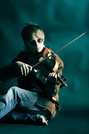 A young woman playing her violin with expression.の写真素材