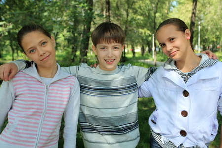 Happy children standing together outdoor.の写真素材
