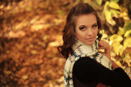 Young pretty woman at the autumn park.の写真素材