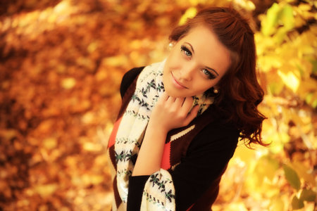 Young pretty woman at the autumn park.の写真素材