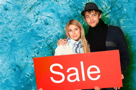 Two young people with advertisement board.の写真素材