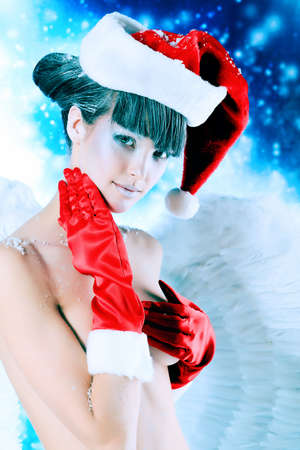 Portrait of a female christmas angel over sky of stars and snow.の写真素材