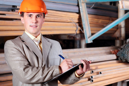 Industrial theme: a blue collar working at a manufacturing area.  