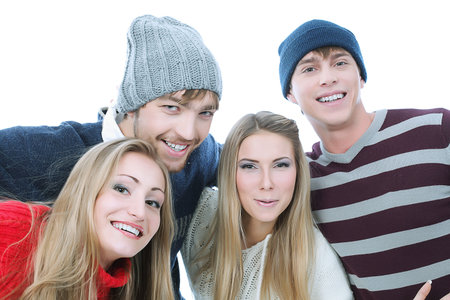 Group of happy young people in warm clothes.