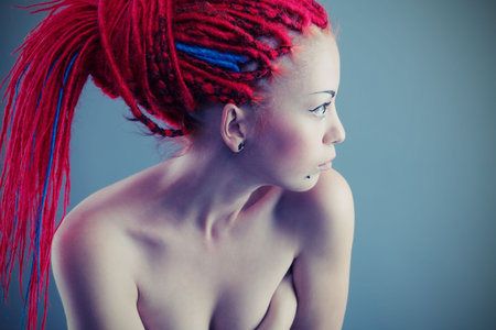 Fashionable young woman with red dreadlocks.の写真素材
