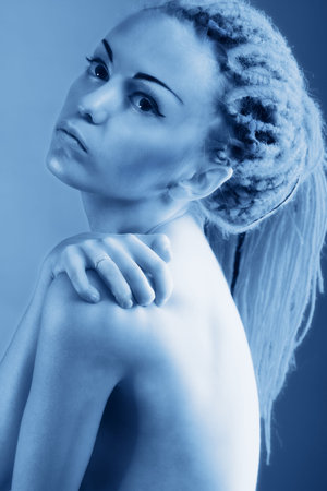 Fashionable young woman with red dreadlocks.