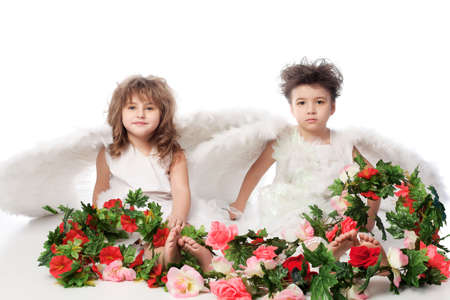 Beautiful little angels holding flowes. Isolated over white background.の写真素材