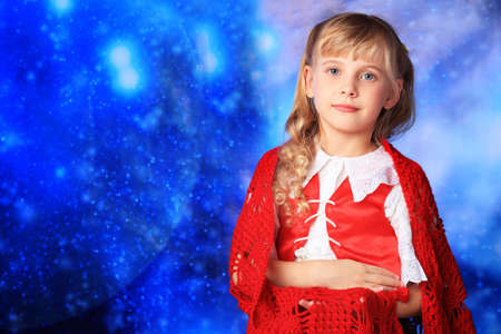 Christmas girl in festive costume over stellar sky.の写真素材